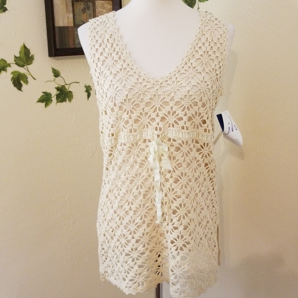 beautiful macrame like top with ribbon detail.